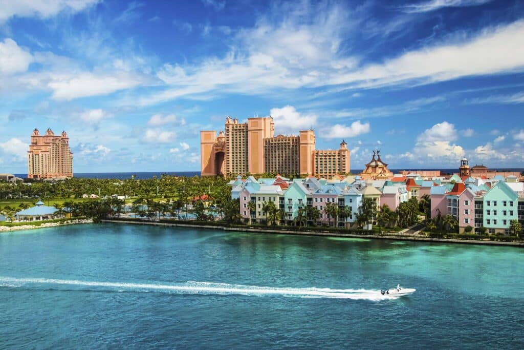 Beautiful scene of speed boat, ocean, colorful houses and a hotel in Nassau, Bahamas on a summer sunny day