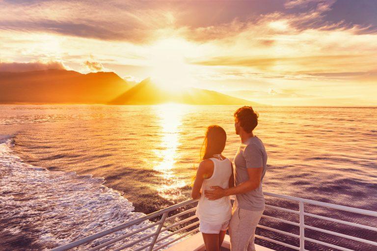 couple watching the sunset on their cruise holidays